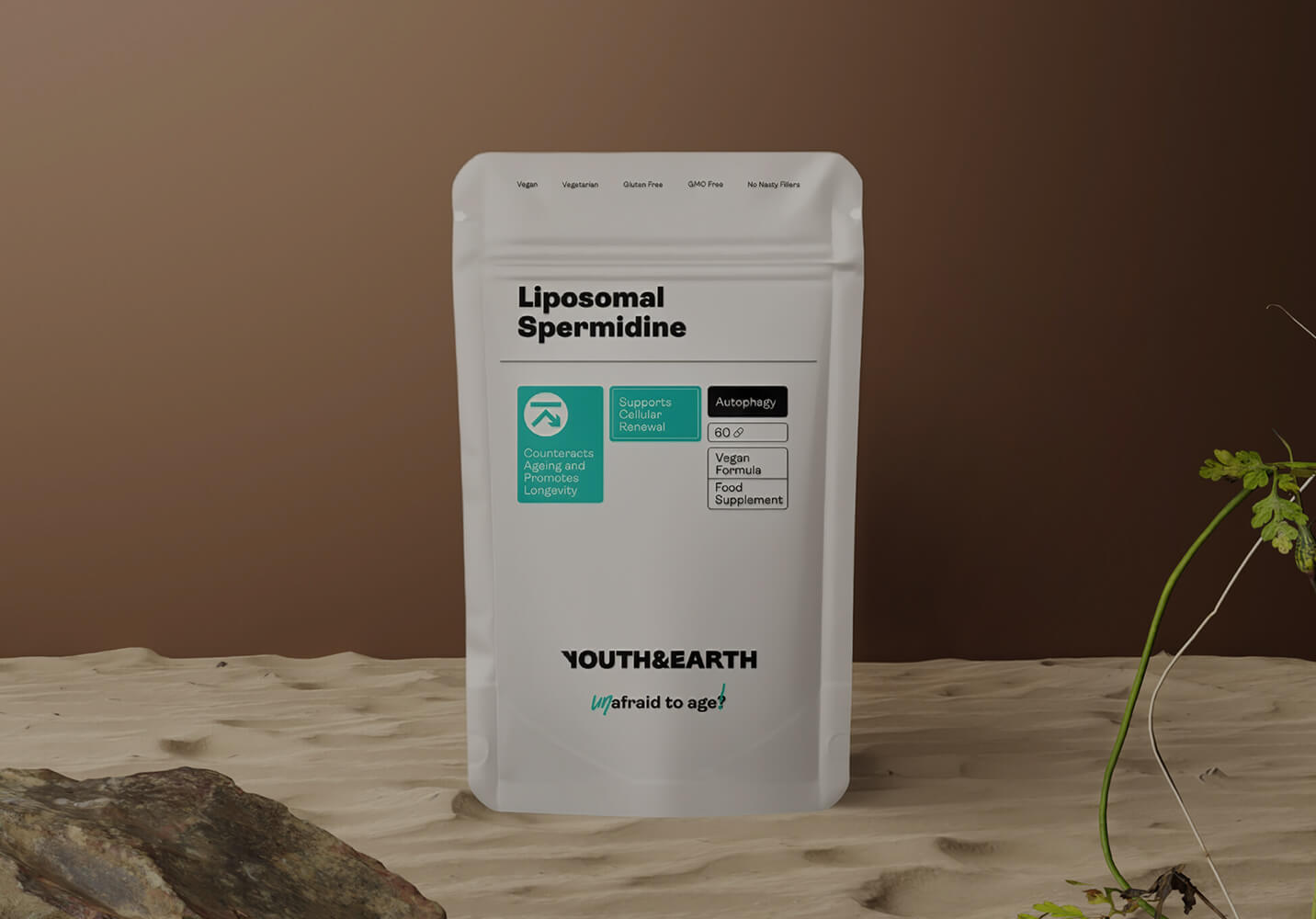 White supplement package labeled 'Liposomal Spermidine' by 'Youth&Earth' on a wooden surface with a brown background.